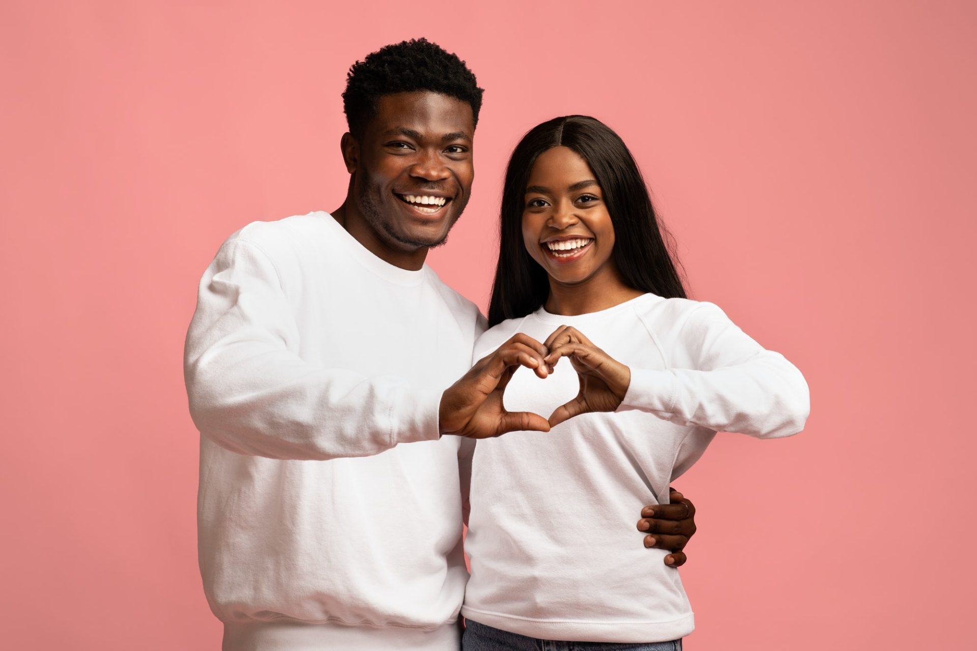 Beautiful loving african american couple showing love gesture