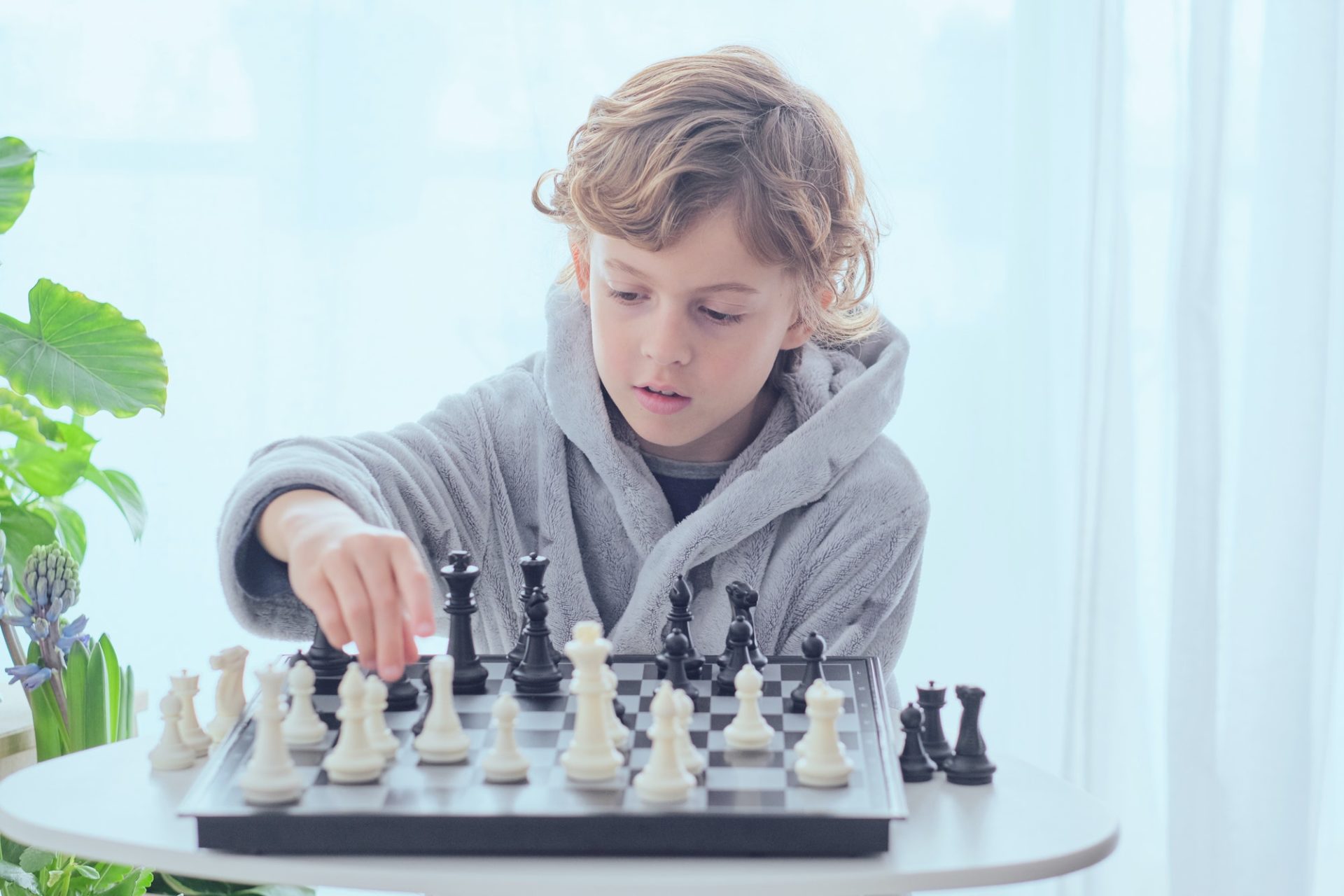 Boy holding figure on chess board