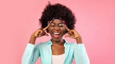 Emotional African Woman Shouting Touching Temples Posing On Pink Background