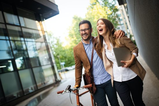 Portrait of happy smiling business people talking in the city