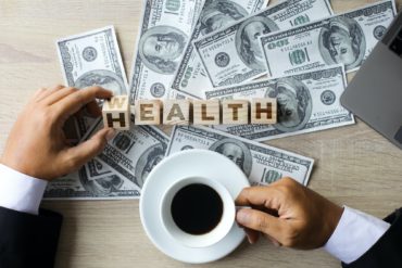 Wealth to Health Inscription with Dollar Bills