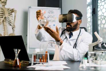 Young African male doctor, scientist, virologist, wearing virtual reality glasses for imagination