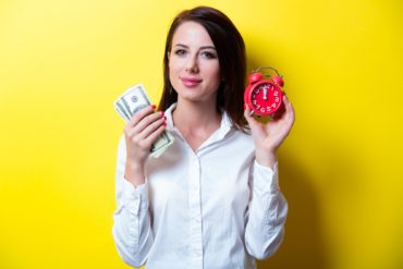young woman with clock and money